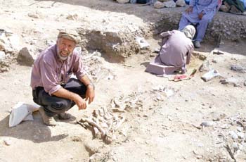 Professor Hans-Peter Uerpmann (University of Tübingen, Germany) examines some burials on the excavation at Jebel Buhais (Photograph by Dr Mark Beech)